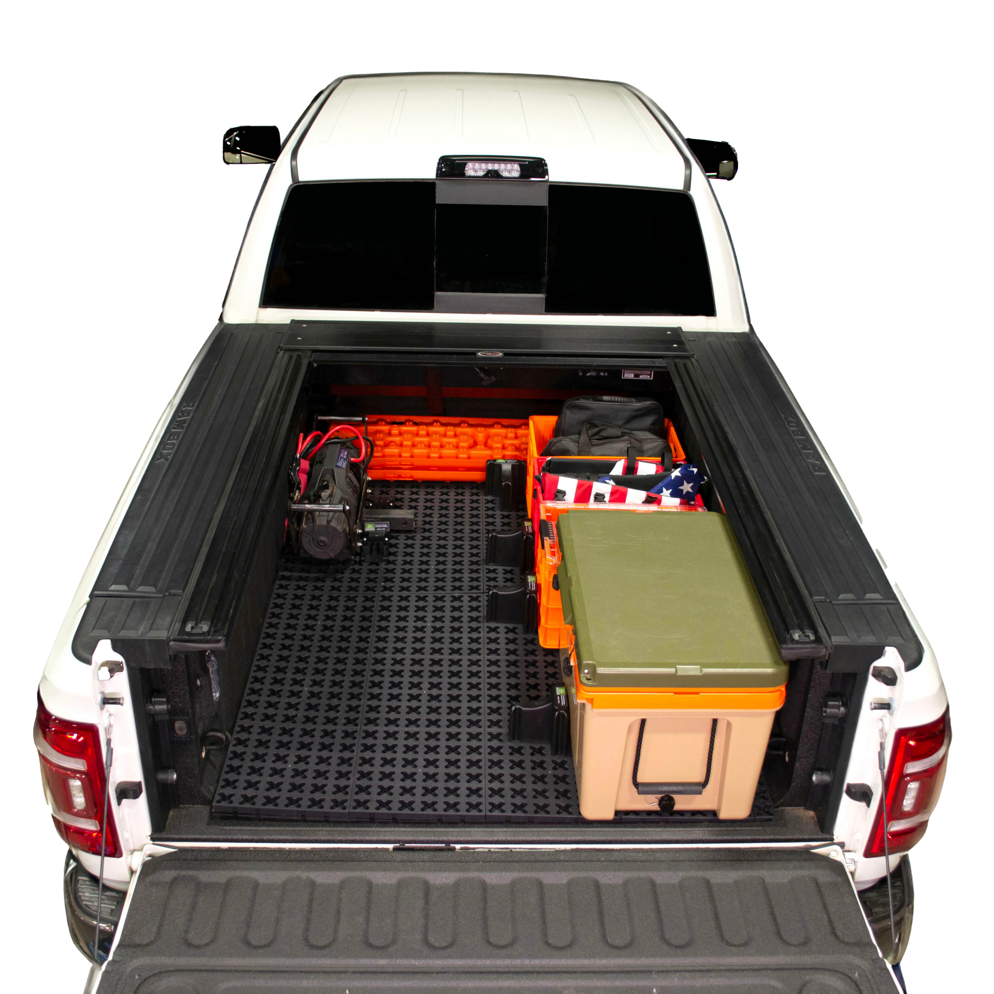 Tmat installed in a Ram 3500 securing a winch, recovery boards, Sidio crates, and a RTIC cooler. 